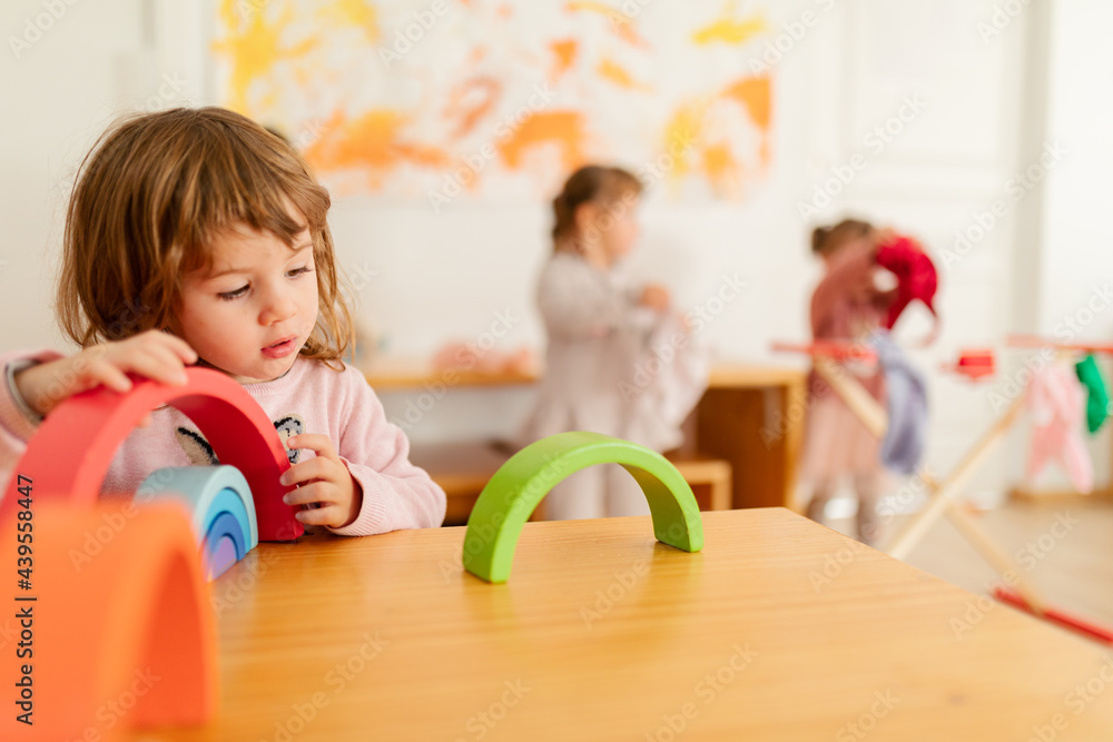 © Javier Pardina/Stocksy - Children playing at the table