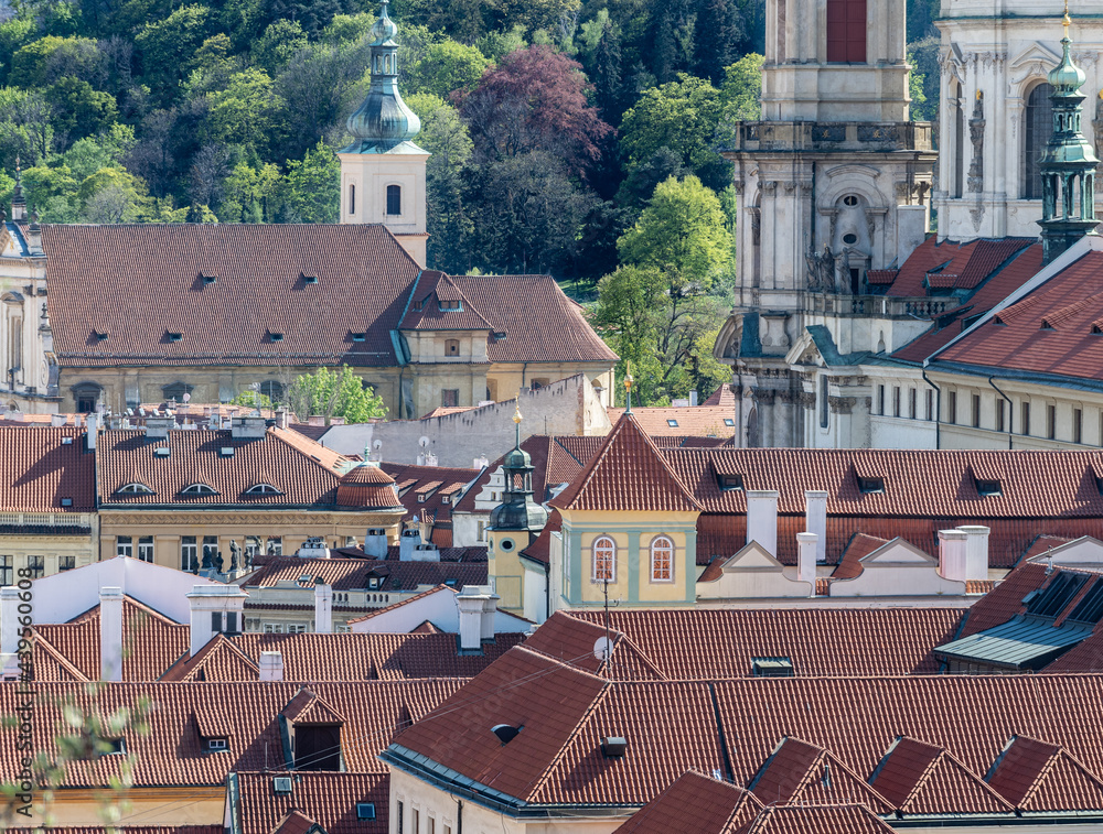 Prague cityscape - shot taken from Prague castle towards Petrin hill, overlooking roof tops and part of St Nicholas cathedral