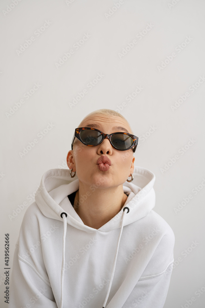 Portrait of Stylish short haired woman in sunglasses Make A Duck Face Portrait of Stylish short haired woman in sunglasses Make A Duck Face