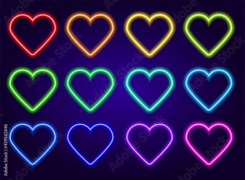 neon colored hearts set. isolated elements glow in the dark line of red, blue, yellow, green and turquoise, pink heart shape, love symbol on dark blue background for design template. The effect of neo photo