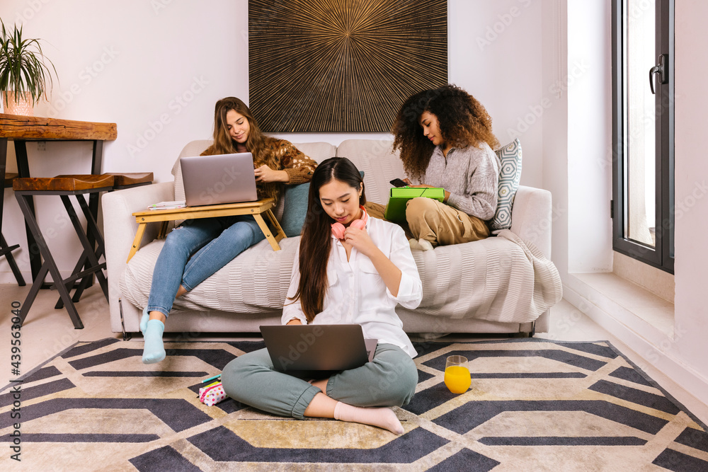 Group of diverse girlfriends doing homework together