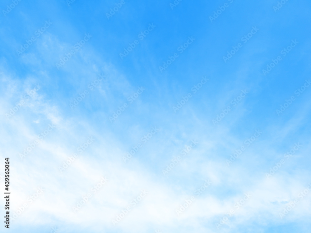 Fototapeta premium Blue sky background with tiny clouds.