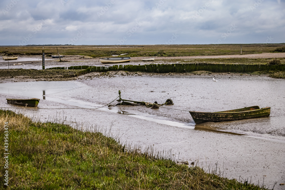 Old boats at Brancaster Staithe, Norfolk, England Old boats at Brancaster Staithe, Norfolk, England