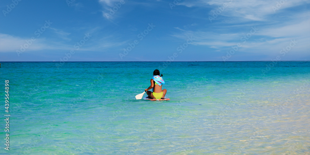 woman kayaking on white sand beach in the  andaman sea 