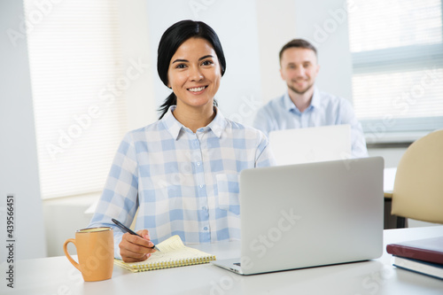 Portrait of businesswoman and her colleague on the background at the office