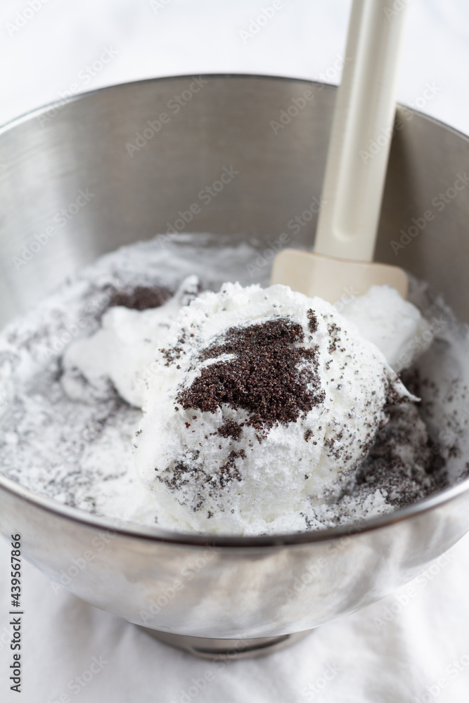 Mixing ingredients for poppy seed meringue in a bowl Mixing ingredients for poppy seed meringue in a bowl