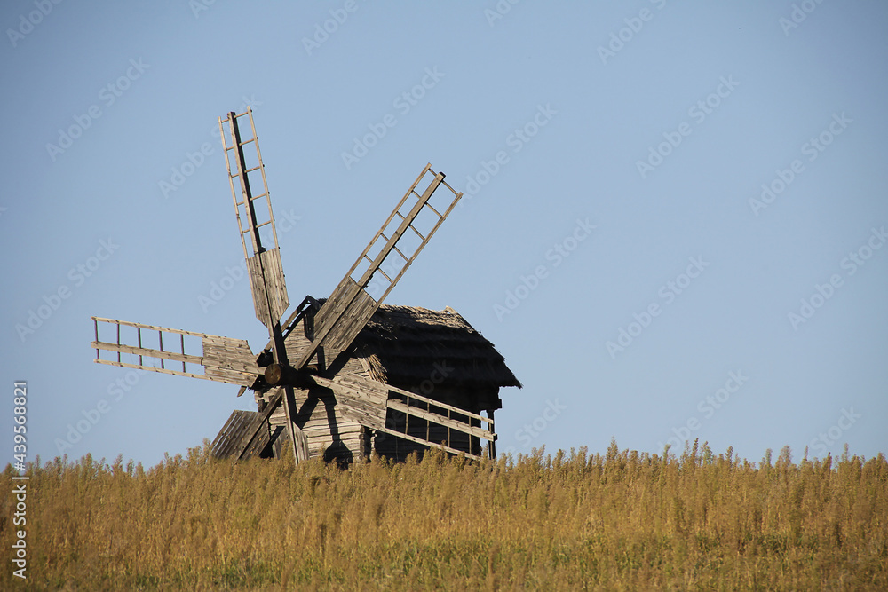 Vintage windmill wooden mill with wind wheel blades.