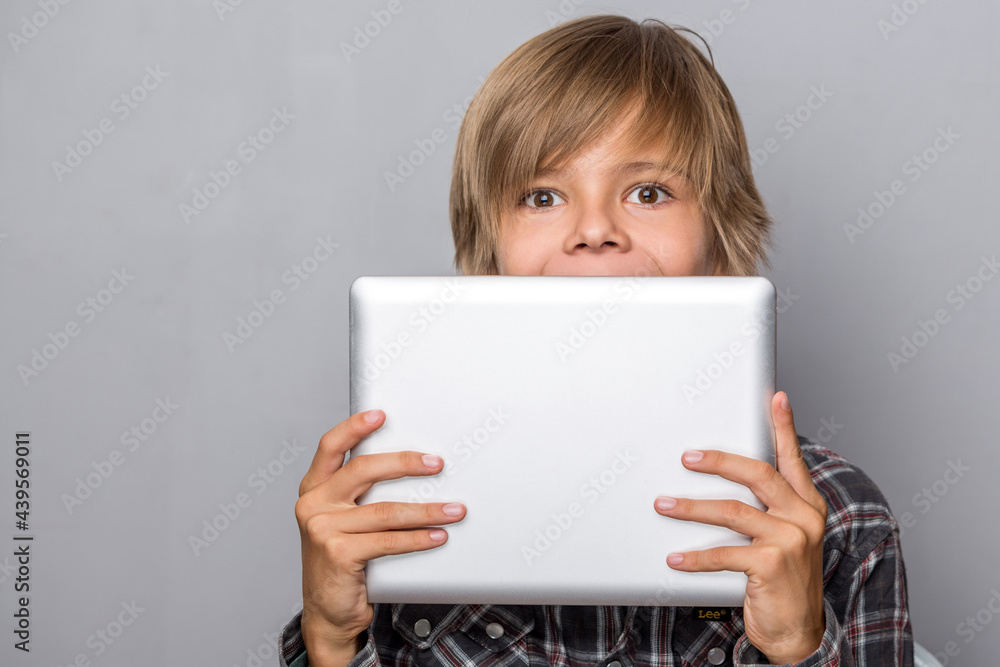 young teenager boy holding table and a book on light background young teenager boy holding table and a book on light background