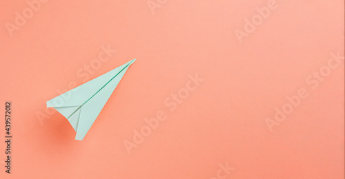 Flat lay of Paper Plane over pastel background with copyspace use for travel holiday concept.