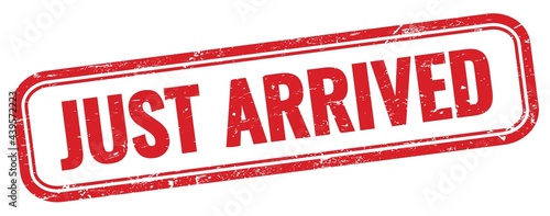 Fotografie JUST ARRIVED text on red grungy stamp.