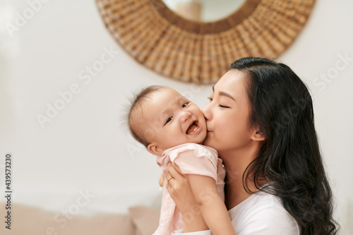 Little child smiling and happy with mom photo
