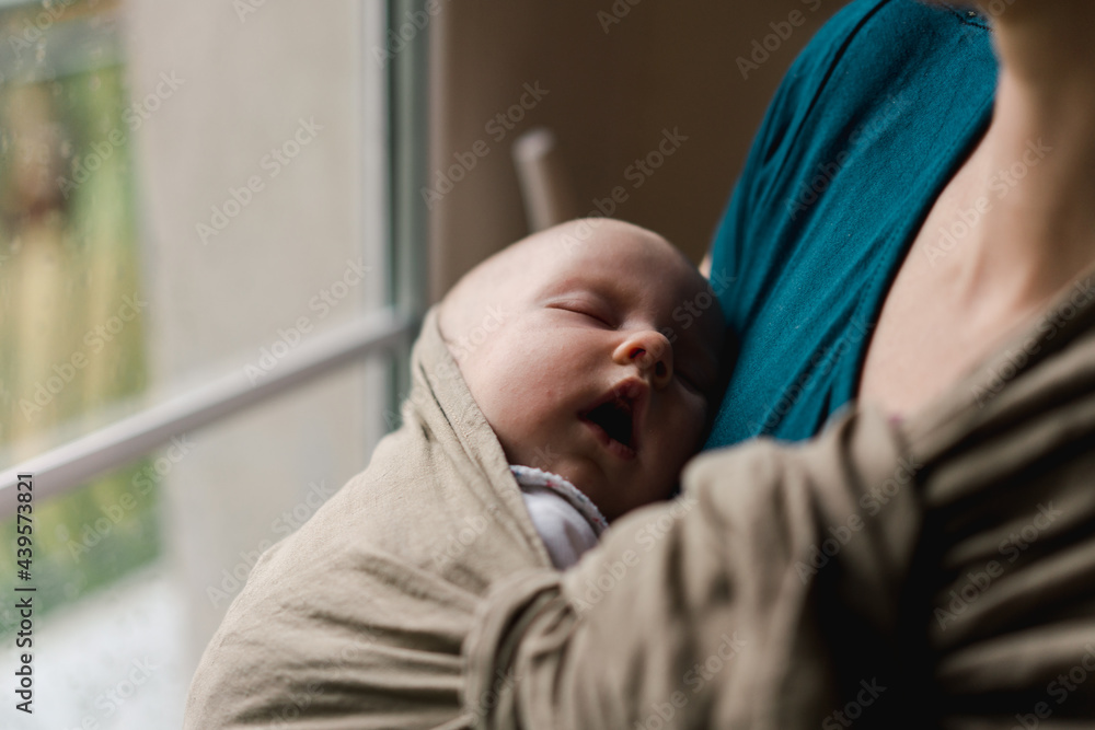 mother wearing her baby in a sling mother wearing her baby in a sling