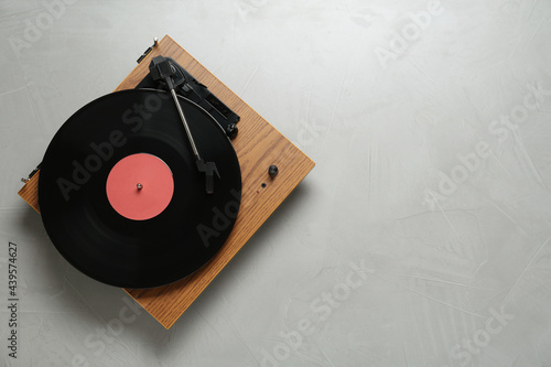 Photography Turntable with vinyl record on light background, top view