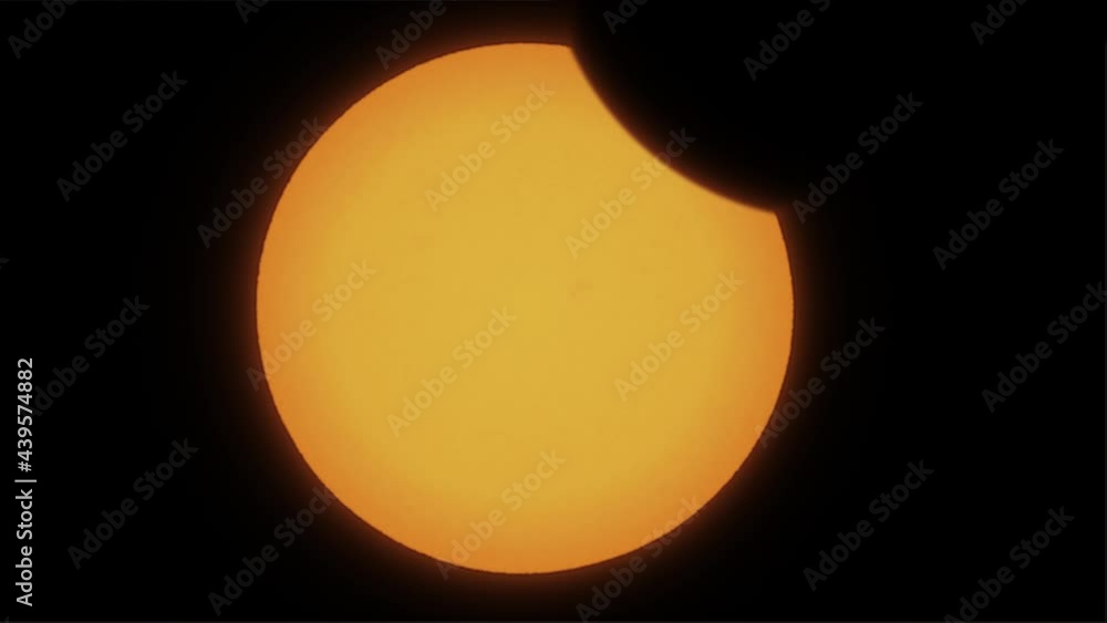 Time lapse of partial solar eclipse close up. The moon mostly covers the visible sun. Natural phenomenon of near full orange sun eclipse. Moon silhuette cast shadows covering yellow sun.