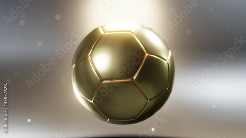 Golden soccer ball spinning in the air. Perfect as football related prize, cup, award or trophy background. Amazing 3d animation. photo