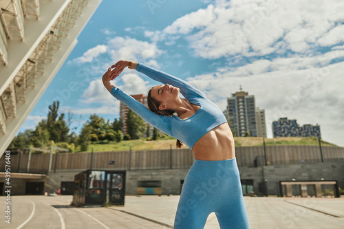 Beautiful fit young woman jogger is running outdoors