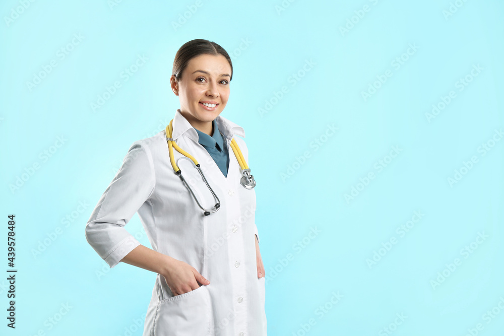 Pediatrician with stethoscope on turquoise background, space for text Pediatrician with stethoscope on turquoise background, space for text
