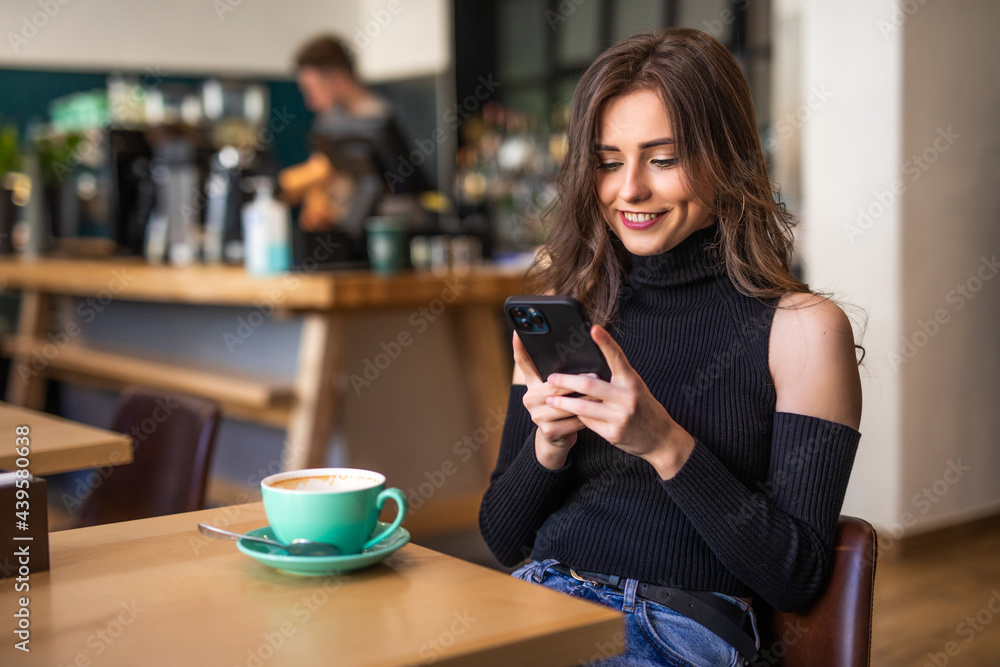 Young woman sitting the cafe with hot beverage Young woman sitting the cafe with hot beverage