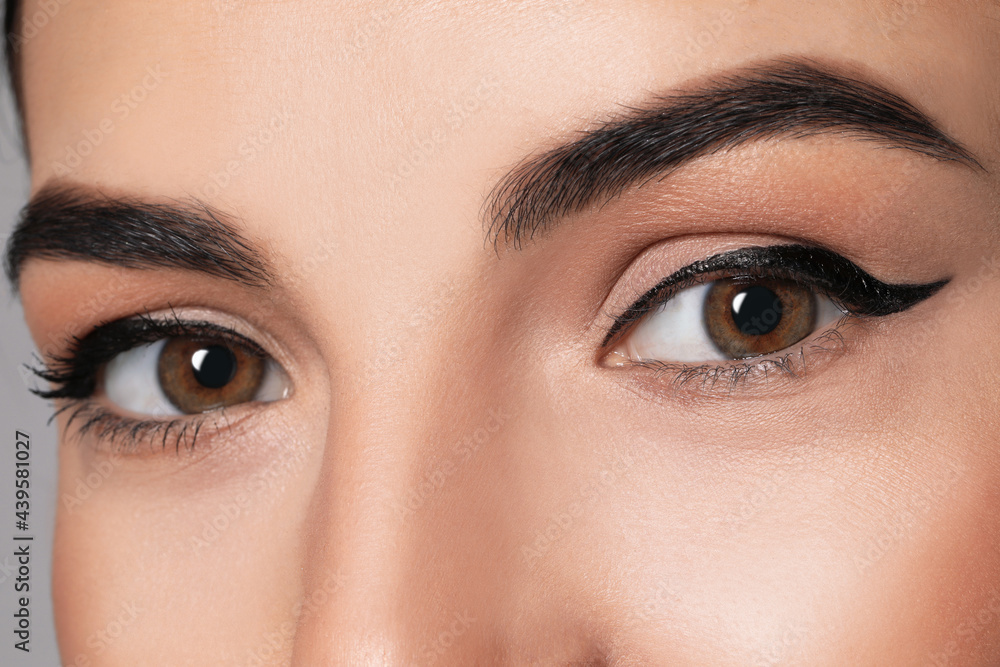 Fototapeta premium Beautiful woman with black eyeliner, closeup view