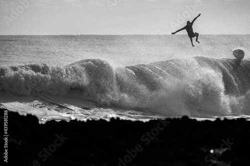 Surfer getting thrown off a wave photo