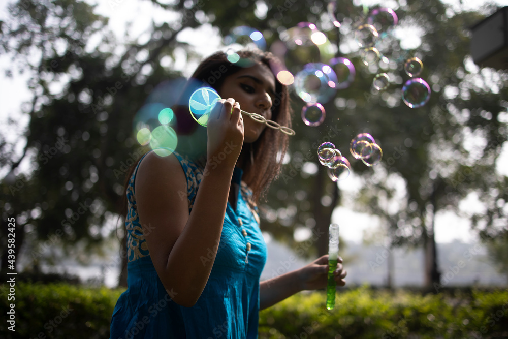 Young girl making fun with bubbles at outdoors Young girl making fun with bubbles at outdoors