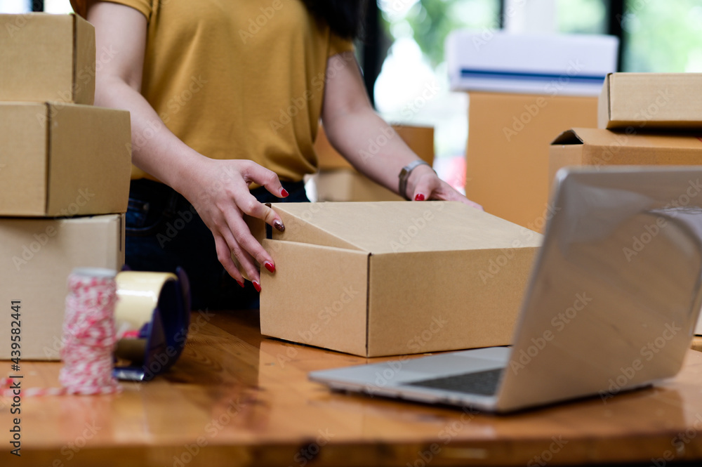 Online sellers are packing boxes for shipping, Online shopping, Shipping parcels. Online sellers are packing boxes for shipping, Online shopping, Shipping parcels.