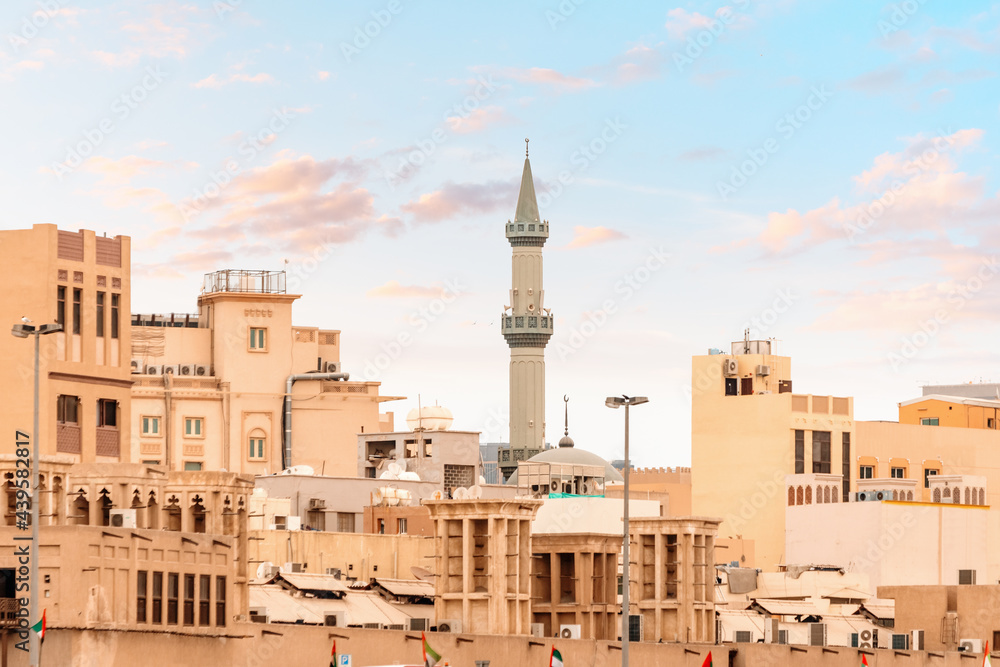 Traditional Arab houses and the towering minaret of the mosque in the neighborhood of Bur Dubai Creek and Golden Souk