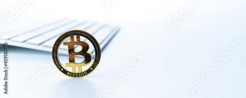 Bitcoin business. Gold Crypto currency BTC Bitcoin with keyboard on white background. Golden Bit Coin virtual cryptocurrency or blockchain technology. Virtual money and mining concept.