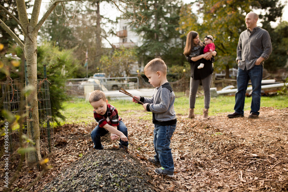 Boys play in gravel pile with family Boys play in gravel pile with family
