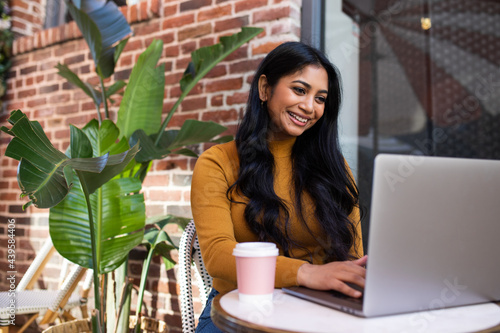 Attractive Woman Works Outdoors on Laptop photo