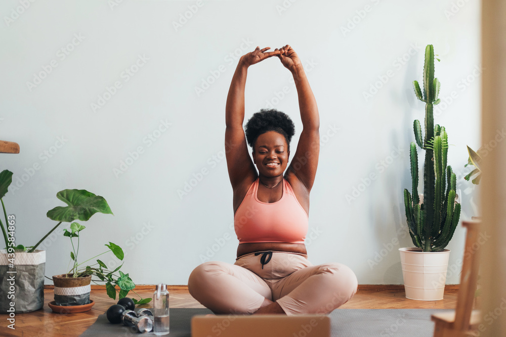 © Studio Firma/Stocksy - Woman Stretching at Home