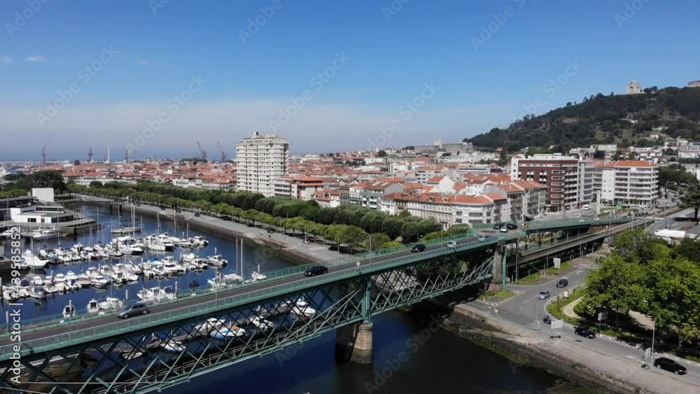 Viana do Castelo, Portugal - June 10, 2021: DRONE AERIAL FOOTAGE - Gustave Eiffel Bridge over the river Lima in Viana do Castelo. Aerial panoramic cityscape view of Viana and the Marina. Viana do Castelo, Portugal - June 10, 2021: DRONE AERIAL FOOTAGE - Gustave Eiffel Bridge over the river Lima in Viana do Castelo. Aerial panoramic cityscape view of Viana and the Marina.