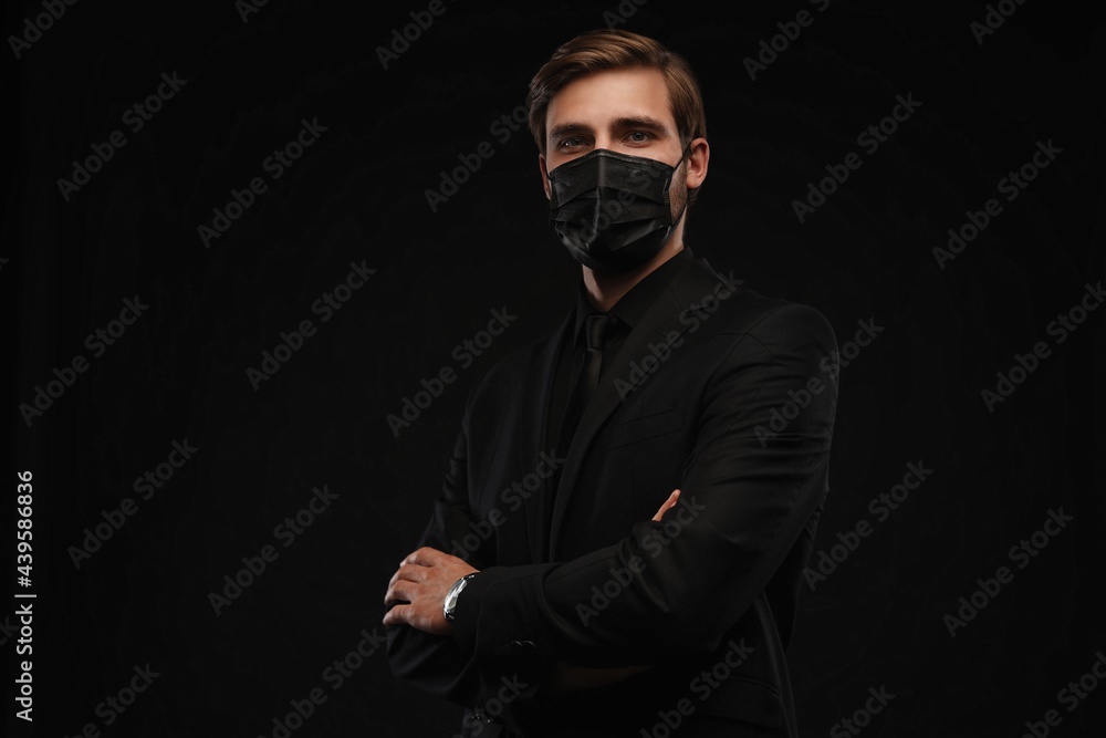 Business Concept - Portrait Handsome Businessman in protective face mask on black background