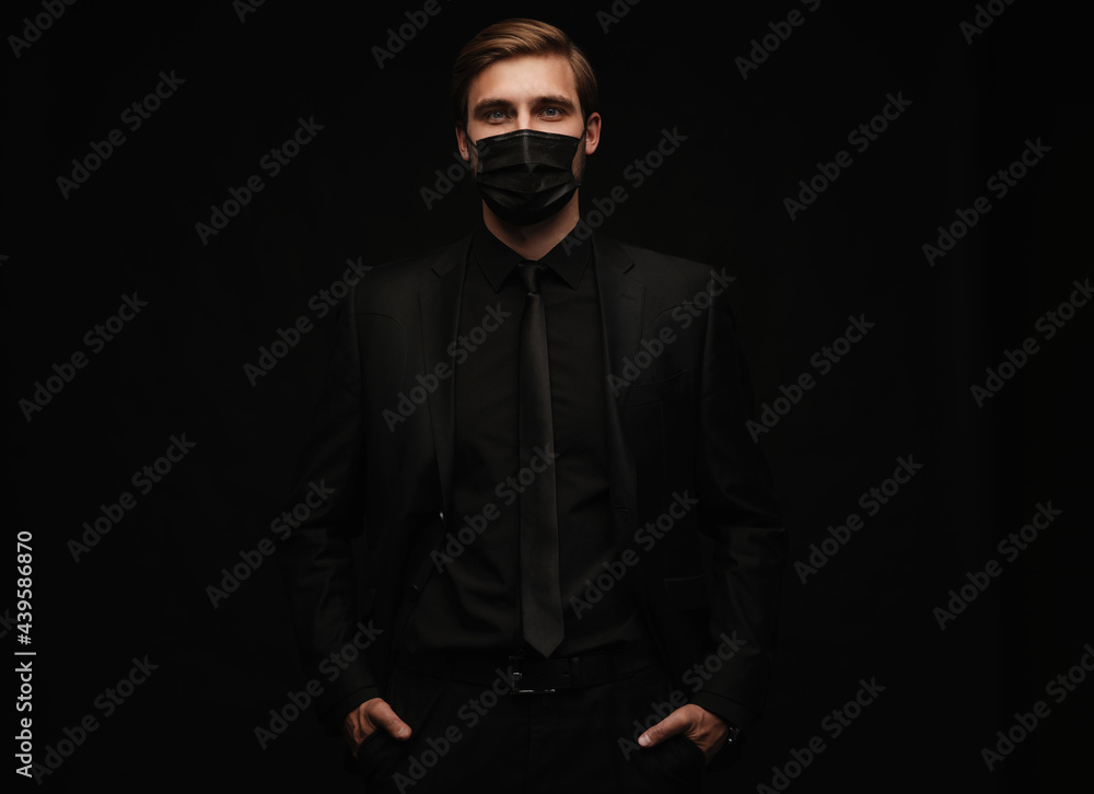 Obraz premium Business Concept - Portrait Handsome Businessman in protective face mask on black background