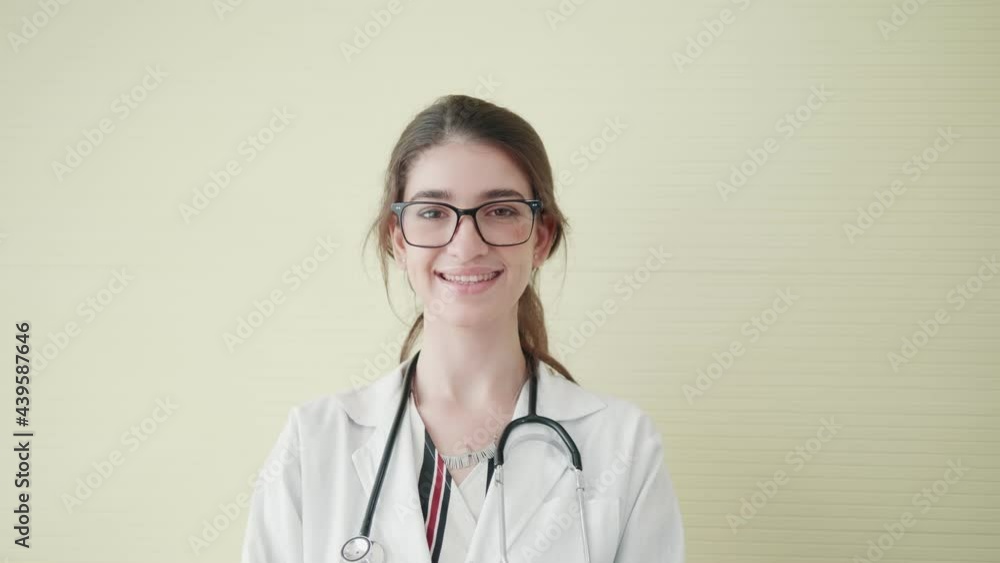 Portrait of smiling female doctor happy european woman wearing a white coat and a stethoscope looks at the camera. Smiling female doctor posing in hospital office. Concept of medicine Portrait of smiling female doctor happy european woman wearing a white coat and a stethoscope looks at the camera. Smiling female doctor posing in hospital office. Concept of medicine