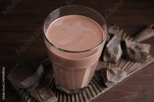 Fresh yummy chocolate milk on wooden table, closeup