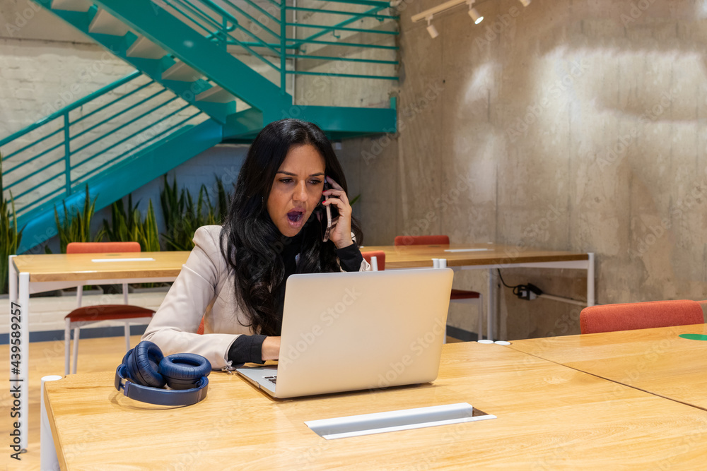 Brunette woman working from her workspace Brunette woman working from her workspace