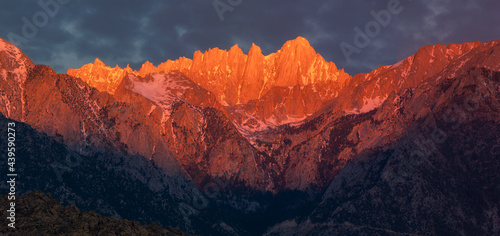 Vivid landscape with mountain range in red-orange sunrise photo