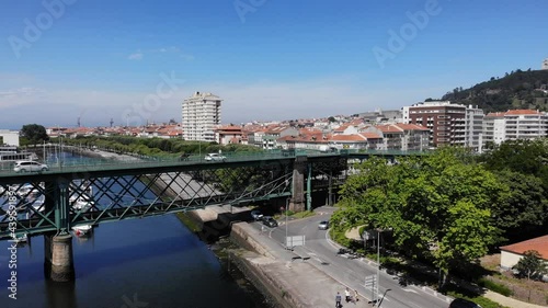 Viana do Castelo, Portugal - June 10, 2021: DRONE AERIAL FOOTAGE - Gustave Eiffel Bridge over the river Lima in Viana do Castelo. Aerial panoramic cityscape view of Viana and the Marina.