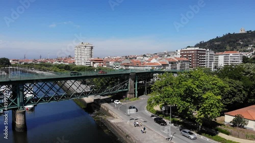 Viana do Castelo, Portugal - June 10, 2021: DRONE AERIAL FOOTAGE - Gustave Eiffel Bridge over the river Lima in Viana do Castelo. Aerial panoramic cityscape view of Viana and the Marina.