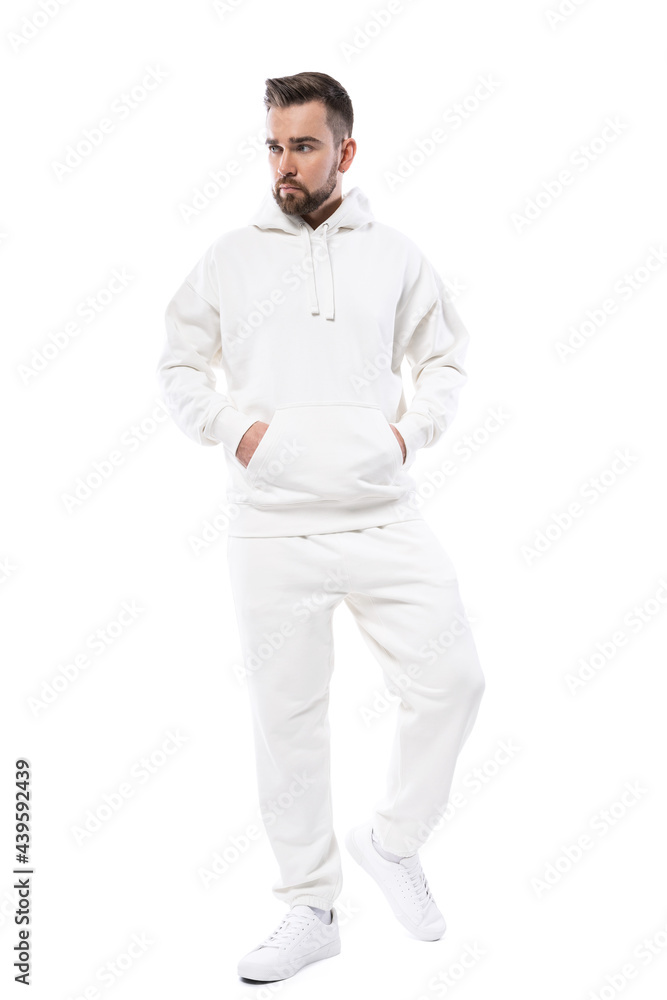 Handsome man wearing blank white hoodie and pants on white background Handsome man wearing blank white hoodie and pants on white background