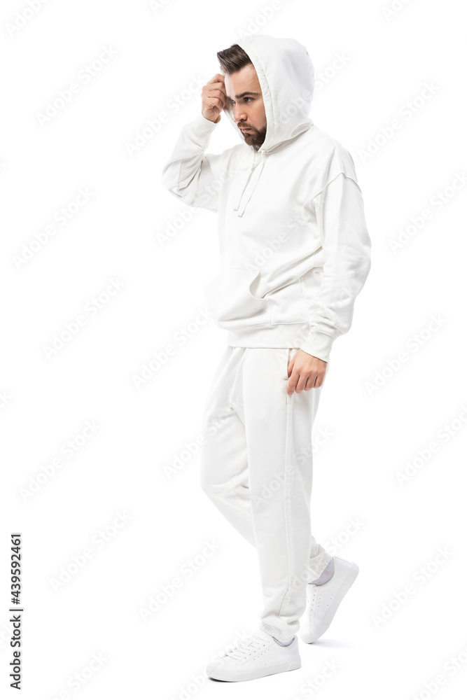 Handsome man wearing blank white hoodie and pants on white background Handsome man wearing blank white hoodie and pants on white background