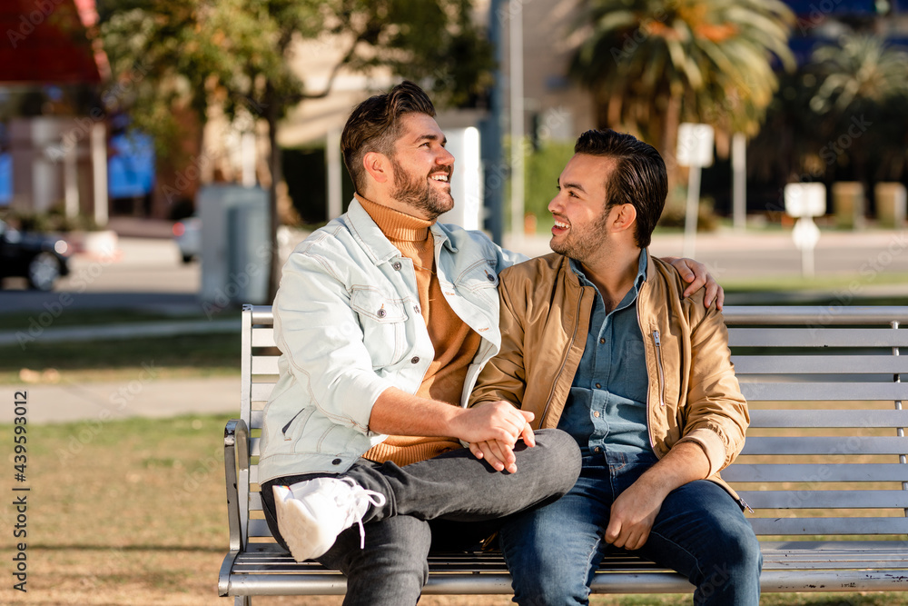 Man Laughs at His Partner's Joke While Sharing a Loving Moment at the Park Man Laughs at His Partner's Joke While Sharing a Loving Moment at the Park