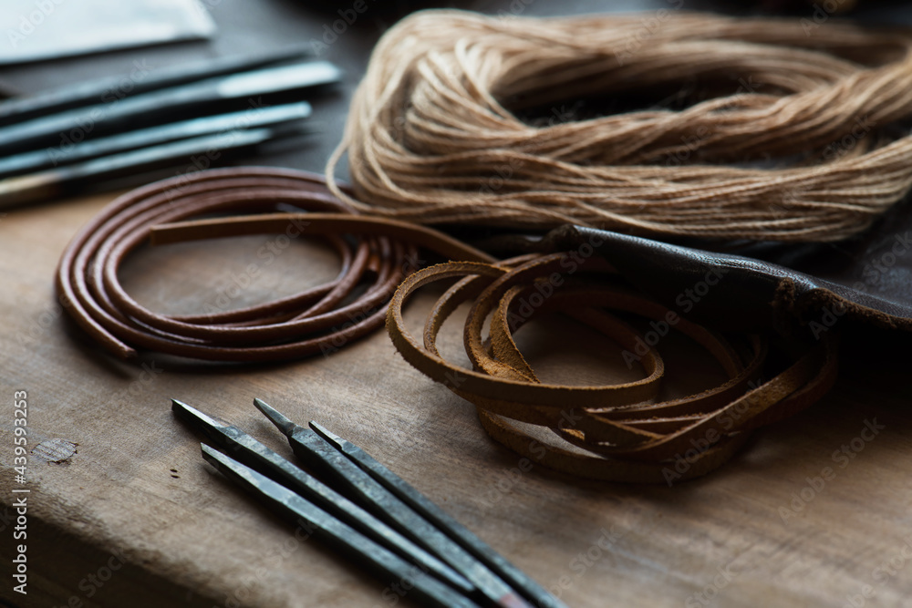 leather craft or leather goods making. work bench of a leather smith. Shallow depth of field. leather craft or leather goods making. work bench of a leather smith. Shallow depth of field.