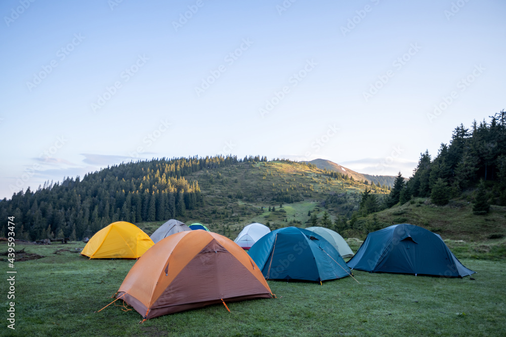 Hiking tents in the mountains set outdoor. Colorful trekking tents outsige