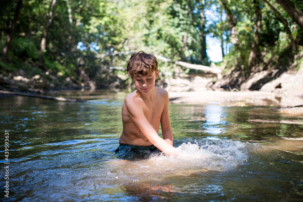 Boy playing in the river Boy playing in the river