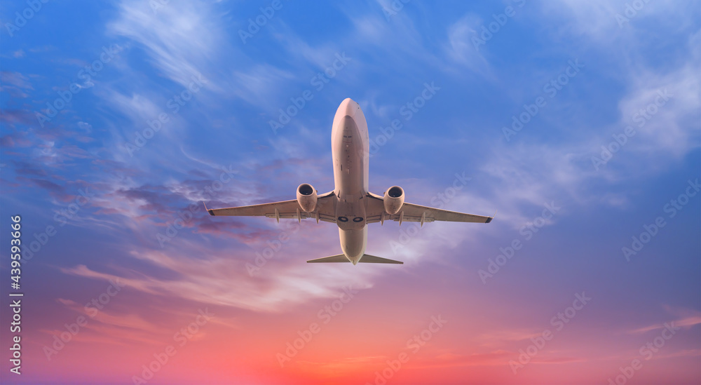White passenger plane soaring towards low clouds - Travel by air transport White passenger plane soaring towards low clouds - Travel by air transport