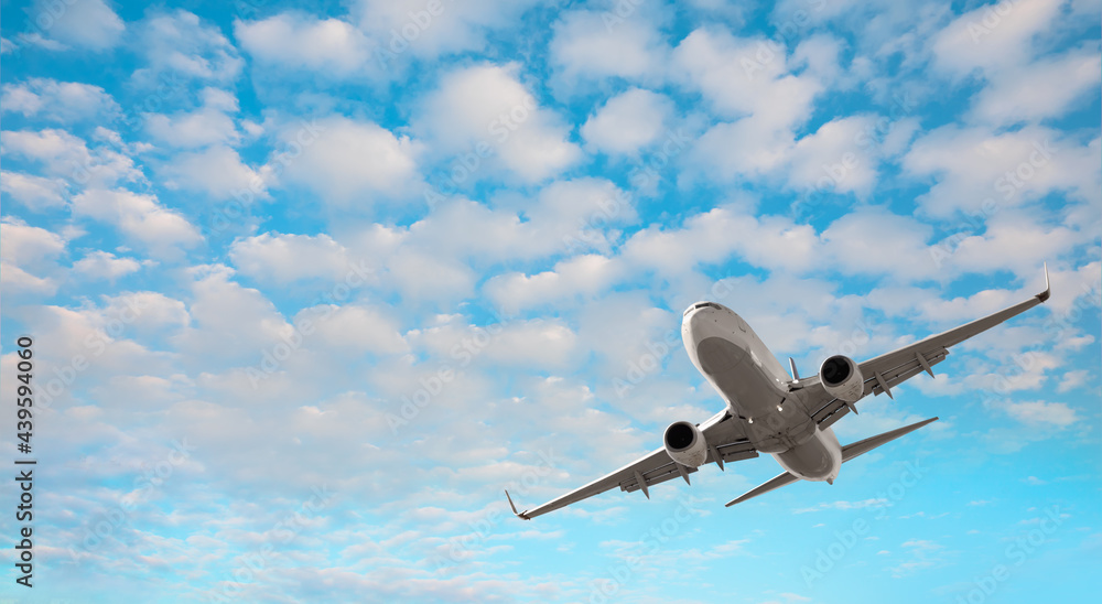 White passenger plane soaring towards low clouds - Travel by air transport White passenger plane soaring towards low clouds - Travel by air transport