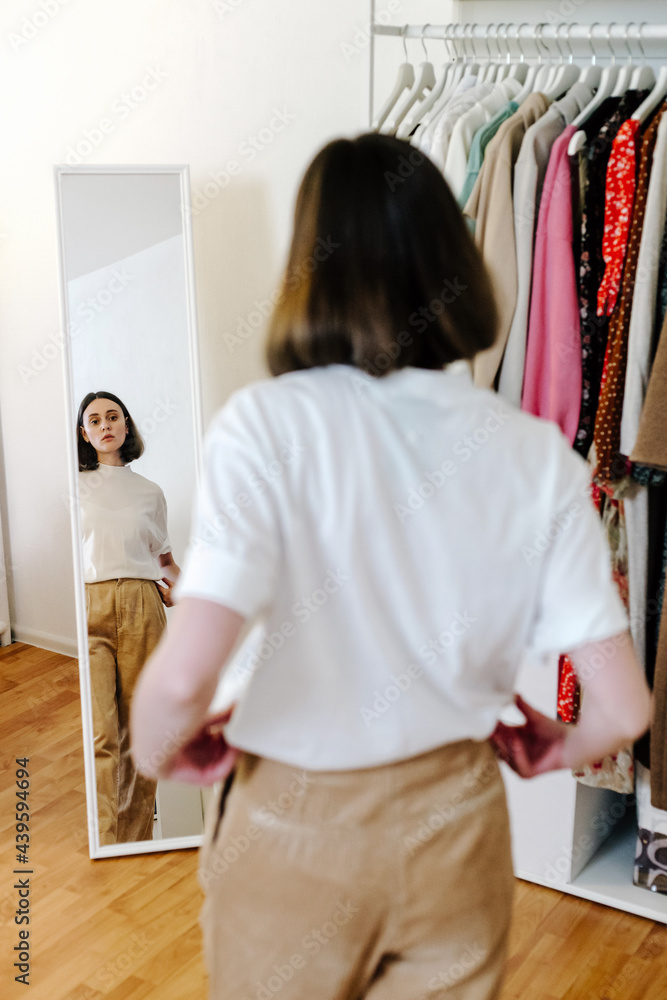 Woman trying on clothes at home Woman trying on clothes at home