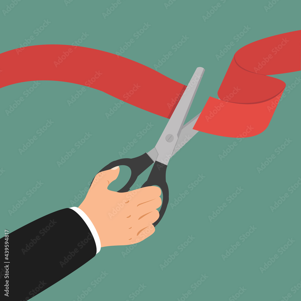 Businessman hand with scissors cuts red ribbon Businessman hand with scissors cuts red ribbon